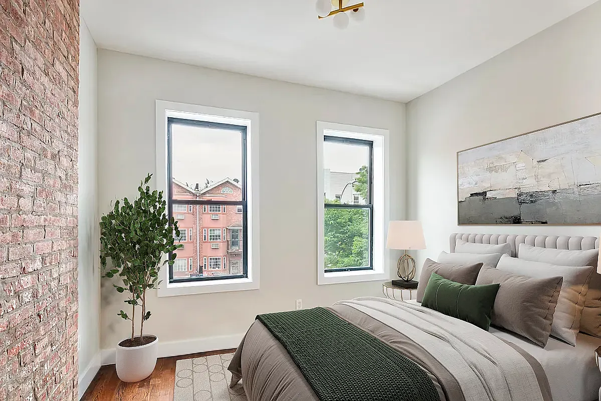285 Cornelia Street, Unit L3 Brooklyn, NY 11221 - Photo 4 of 10 a bedroom with a large bed and a potted plant