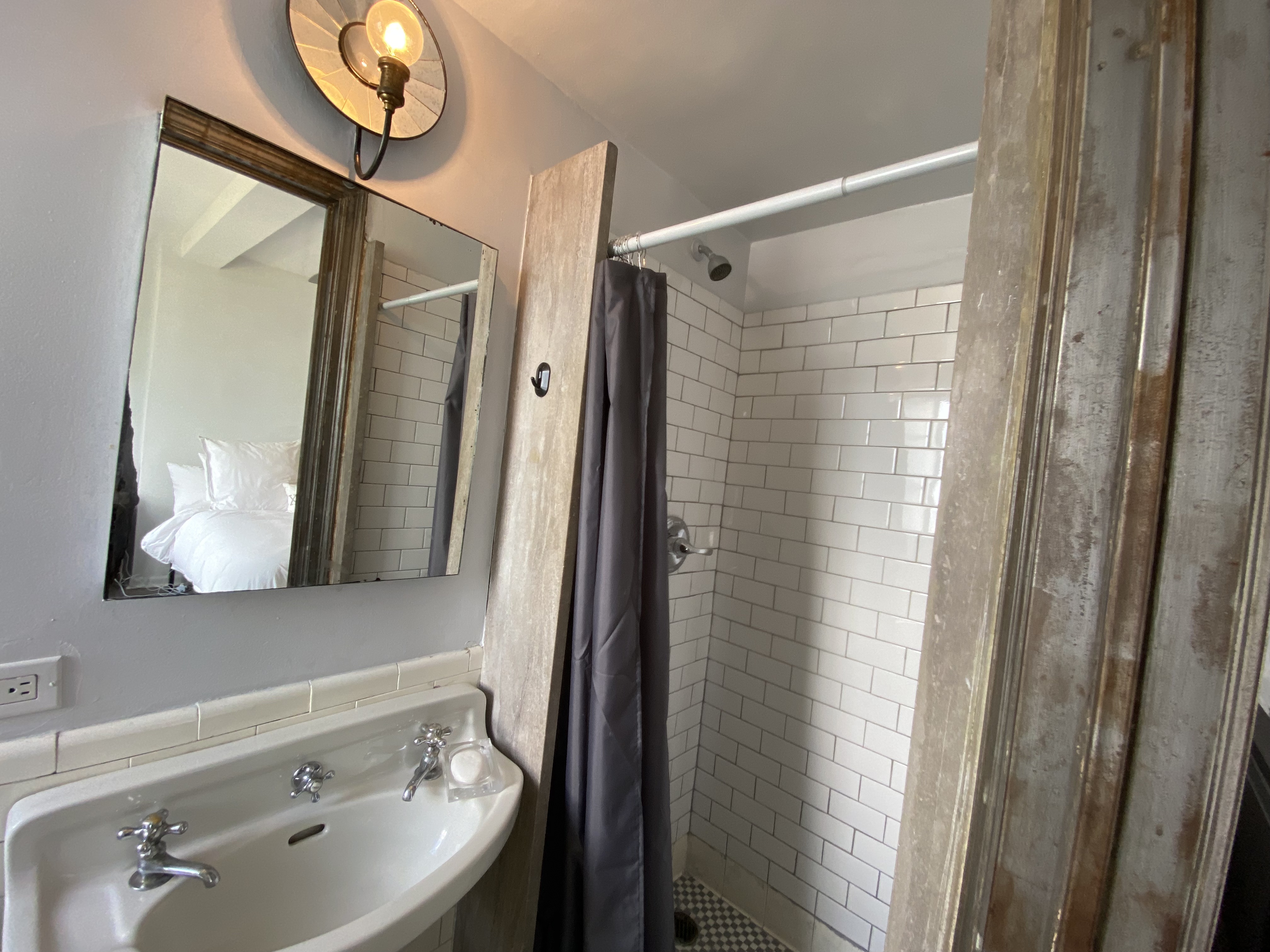 5 Tudor City Place, Unit 1226 Manhattan, NY 10017 - Photo 8 of 10 a bathroom with a sink a mirror a vanity and shower