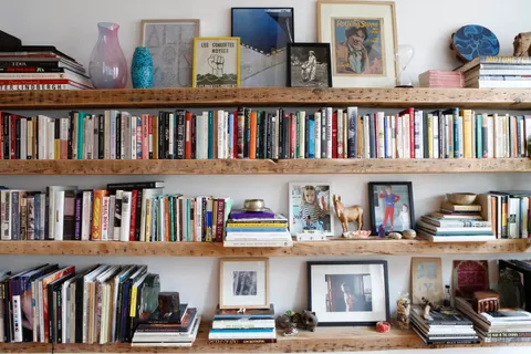 a view of a living room that has a lots of books