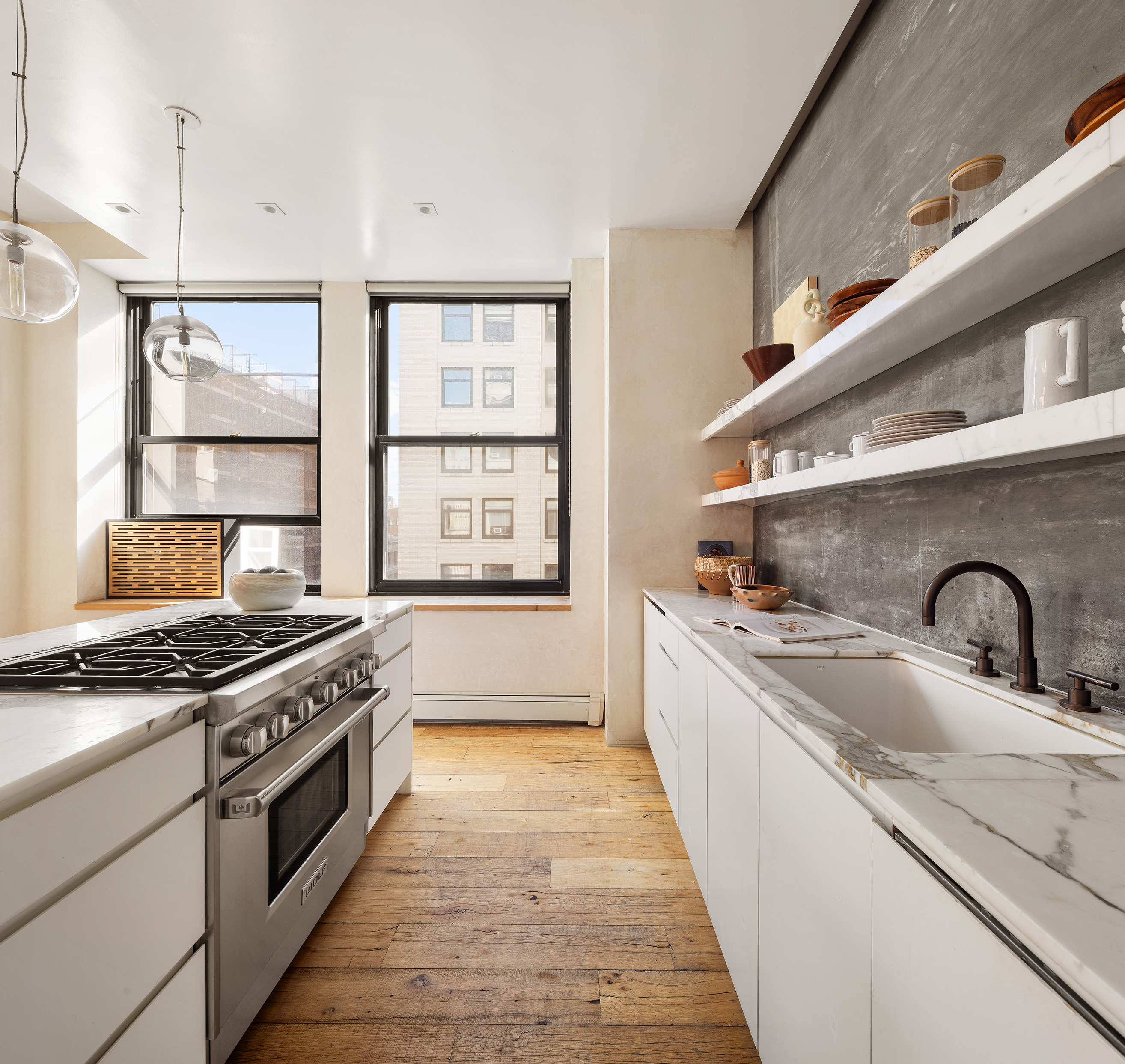 250 Mercer Street, Unit B706B707 Manhattan, NY 10012 - Photo 12 of 25 a kitchen with stainless steel appliances granite countertop a sink stove and cabinets