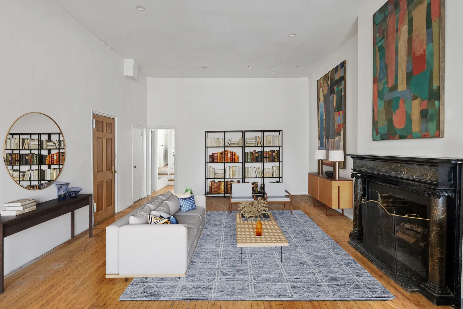 a living room with furniture fireplace and wooden floor