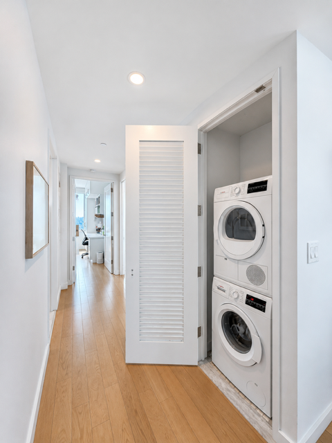 22 North 6th Street, Unit 23K Brooklyn, NY 11249 - Photo 8 of 11 a view of a hallway with washer and dryer