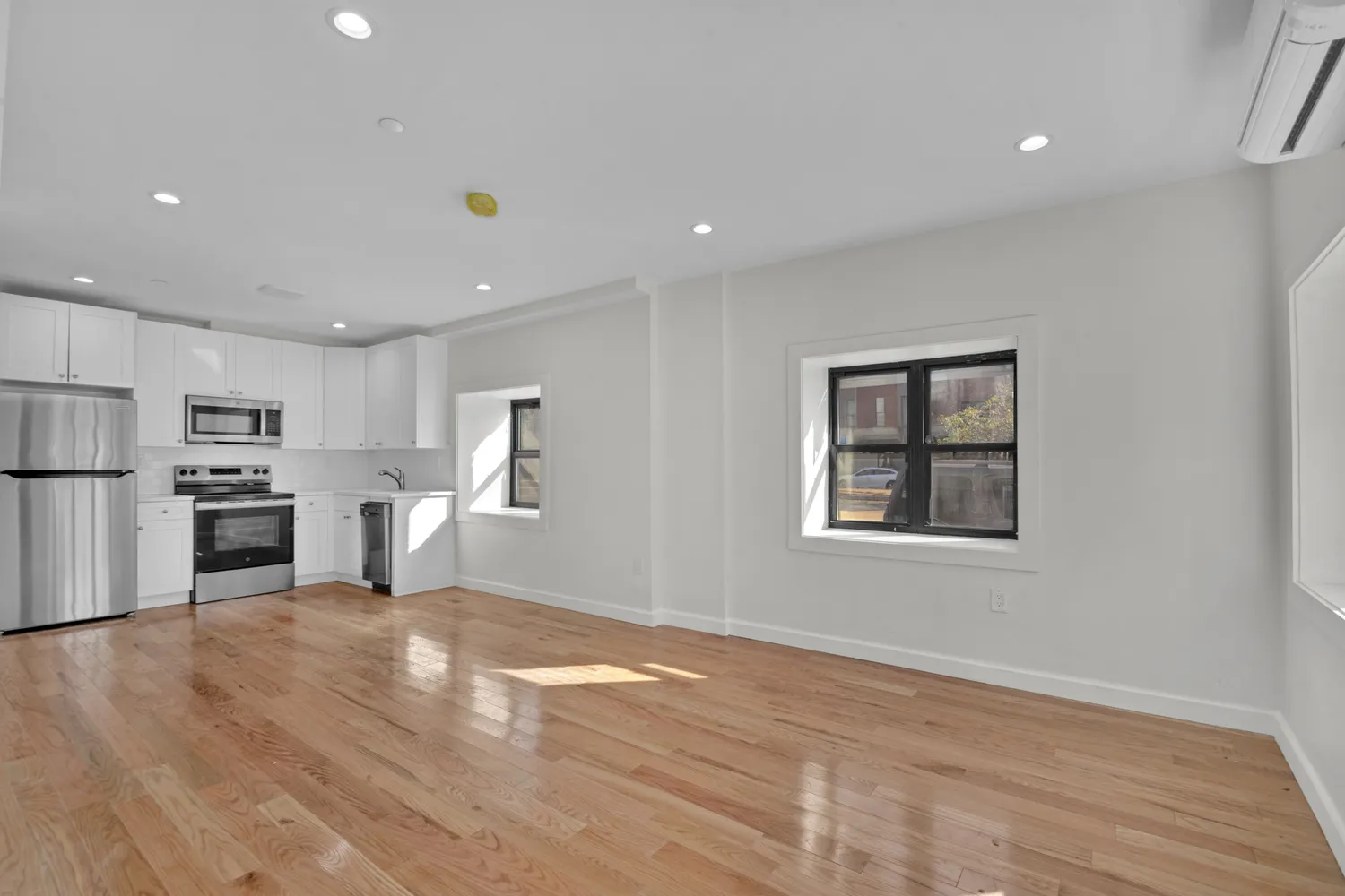 a view of kitchen with wooden floor and electronic appliances