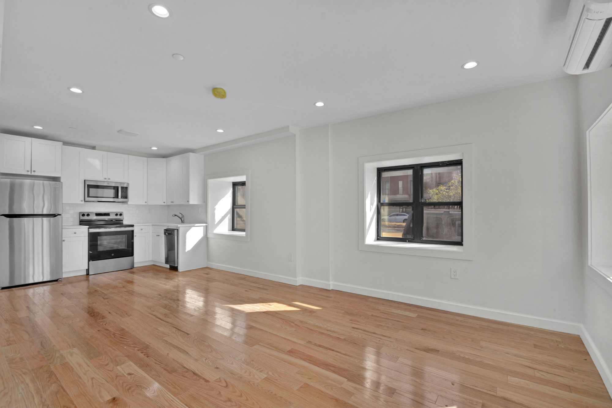 31 Roosevelt Place, Unit 1A Brooklyn, NY 11233 - Photo 1 of 14 a view of kitchen with wooden floor and electronic appliances