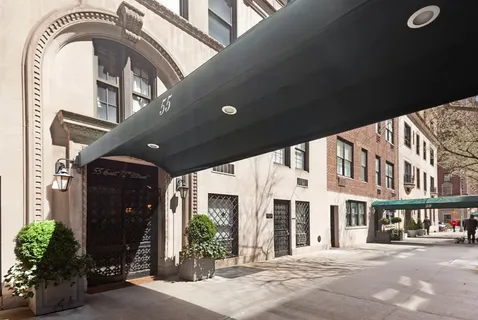 a front view of a building with a garden