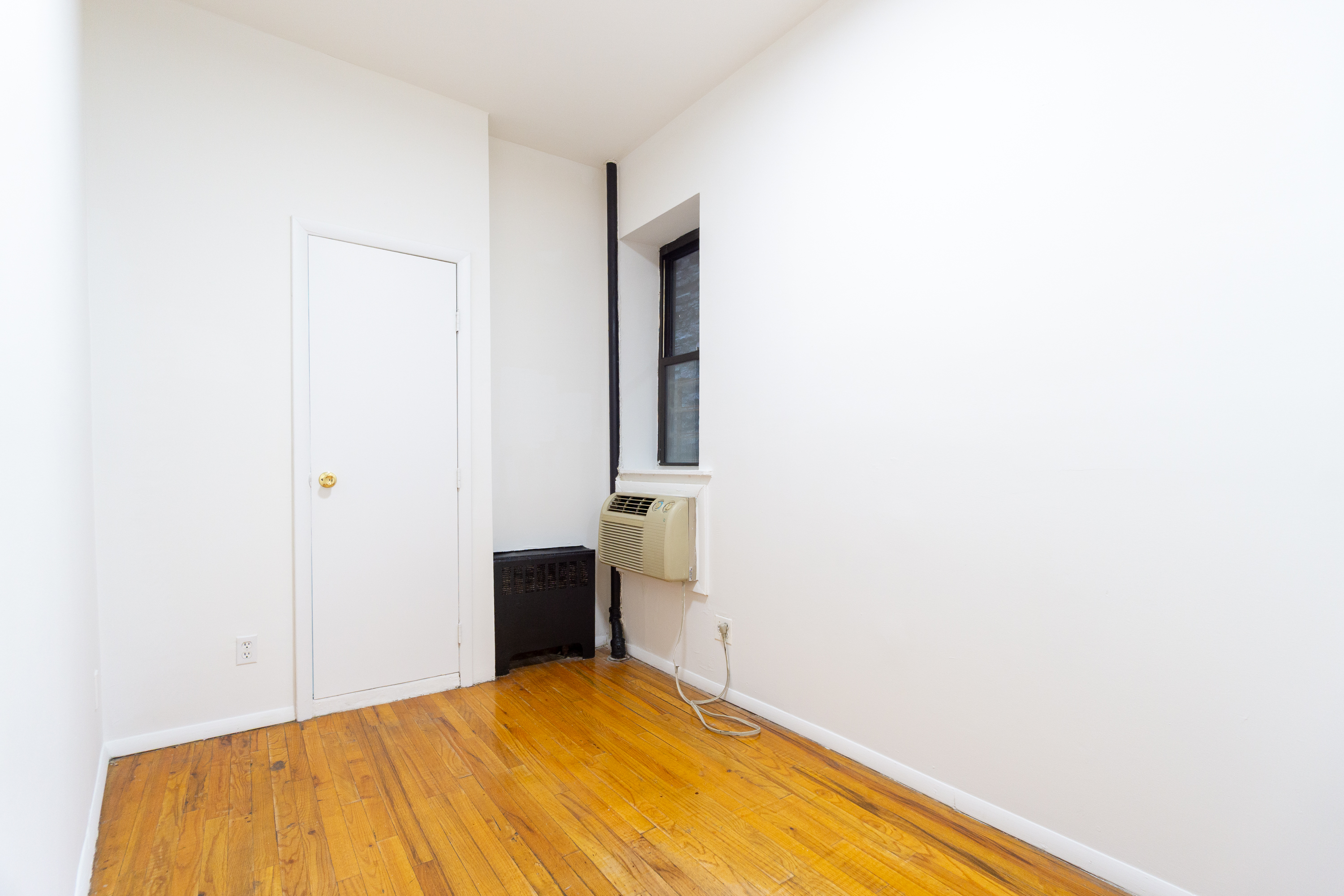 319 East 25th Street, Unit 1B Manhattan, NY 10010 - Photo 7 of 15 a bedroom with a bed and a table