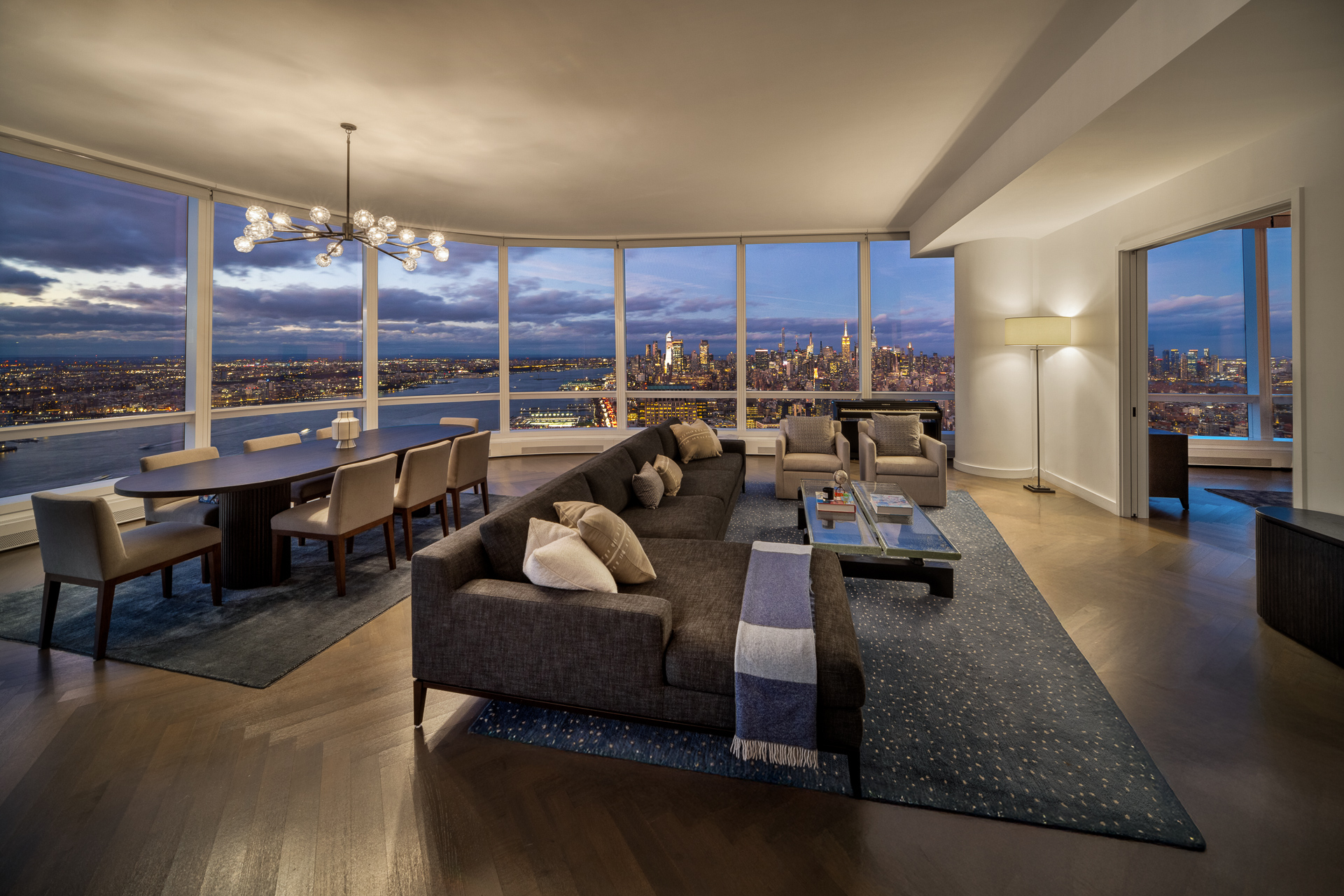 111 Murray Street, Unit 61W Manhattan, NY 10007 - Photo 2 of 35 a living room with furniture kitchen view and large windows