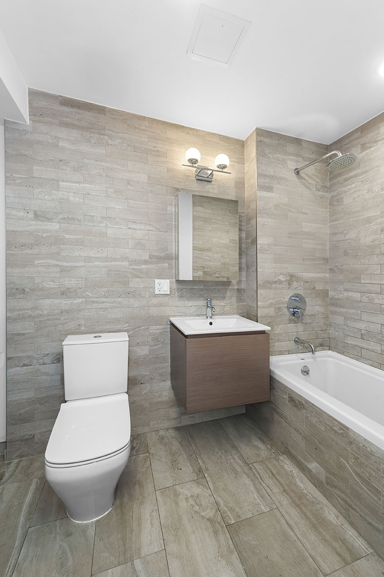 686 MacDonough Street, Unit 2A Brooklyn, NY 11233 - Photo 7 of 8 a bathroom with a toilet a sink and bathtub