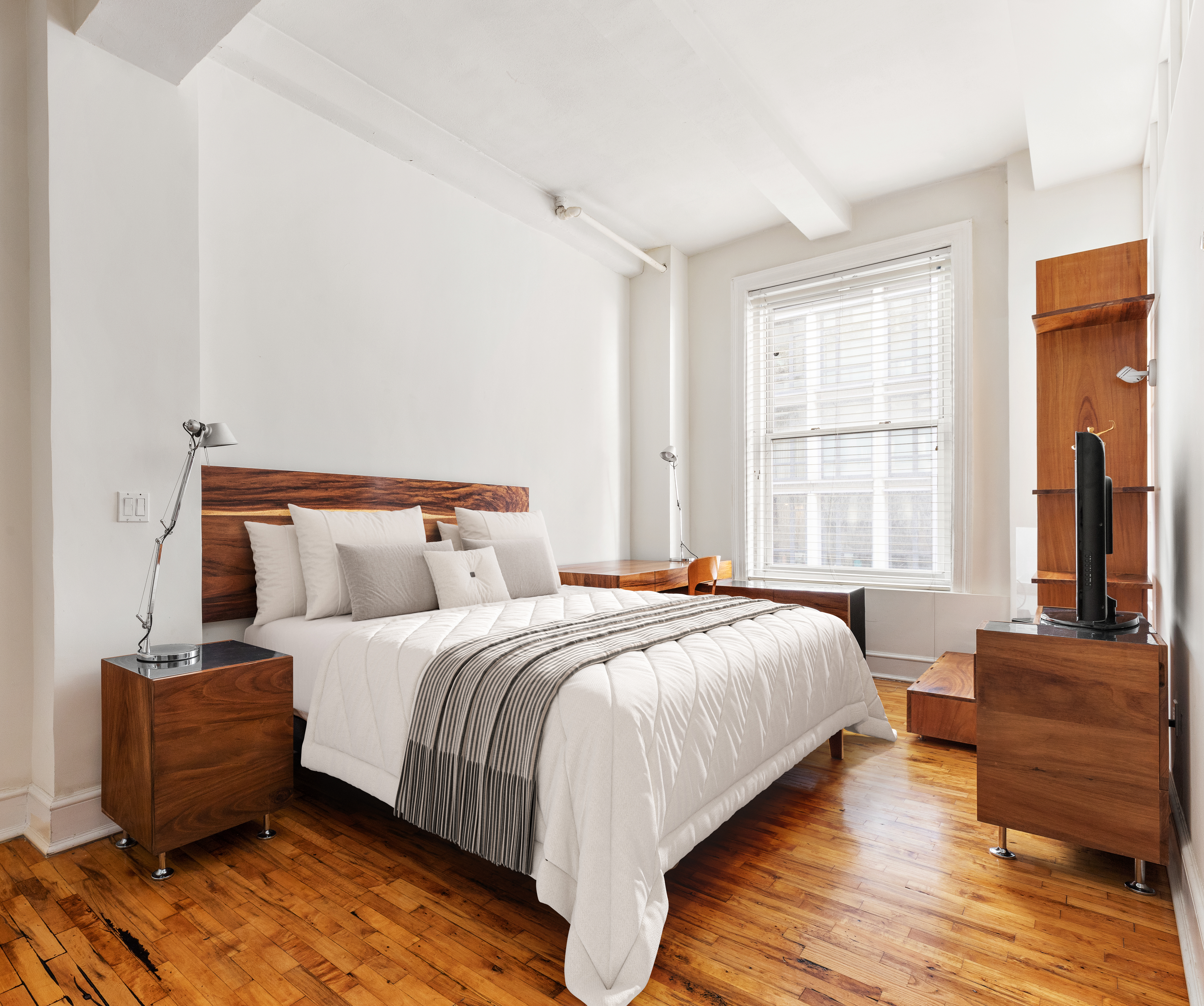 126 West 22nd Street, Unit 5N Manhattan, NY 10011 - Photo 5 of 13 a bedroom with bed and wooden floor