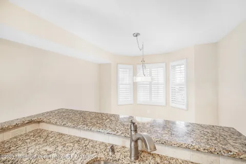 a view of a bedroom with a bed and wooden floor