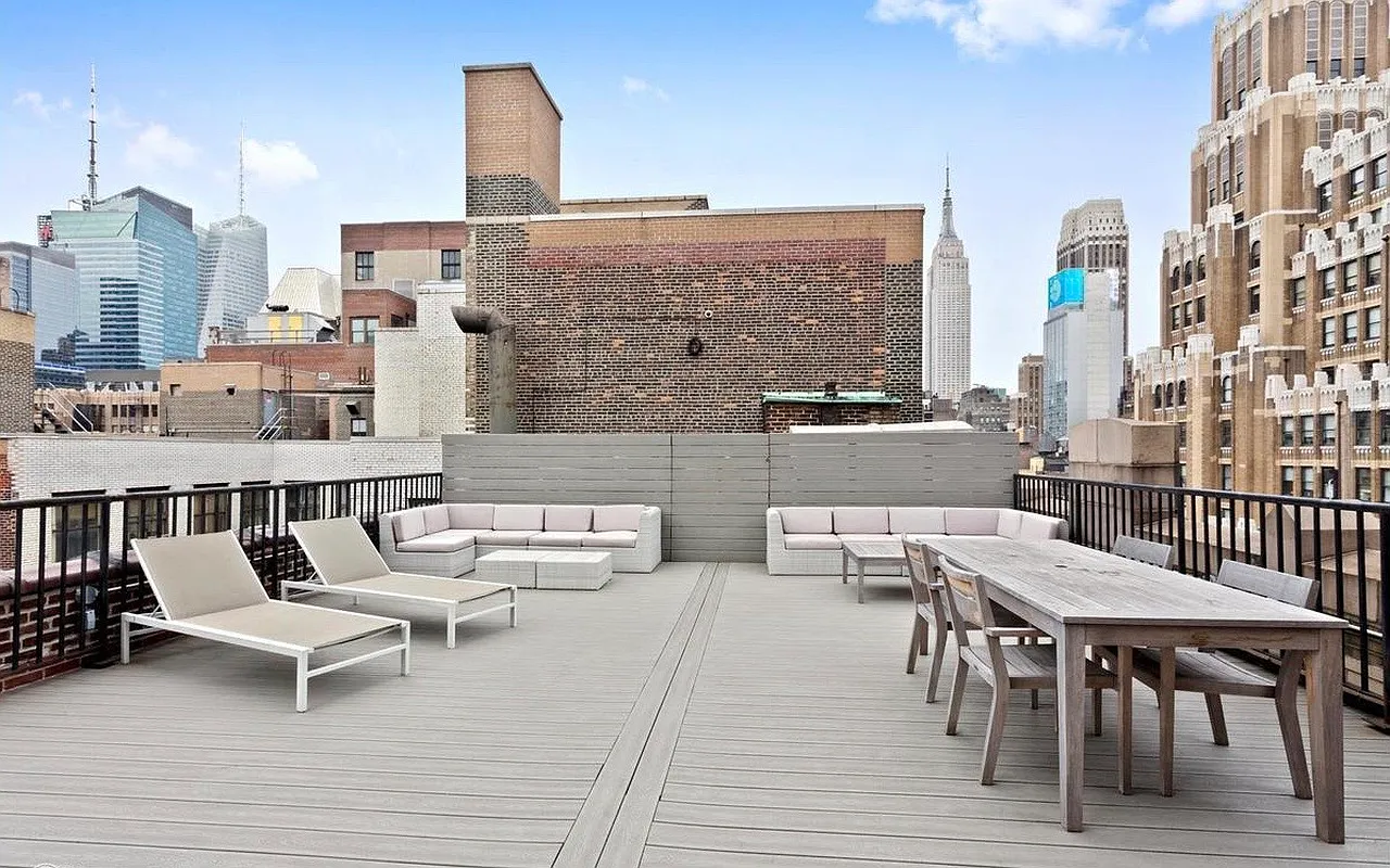 315 West 36th Street, Unit 11D Manhattan, NY 10018 - Photo 9 of 10 a view of a roof deck with table and chairs