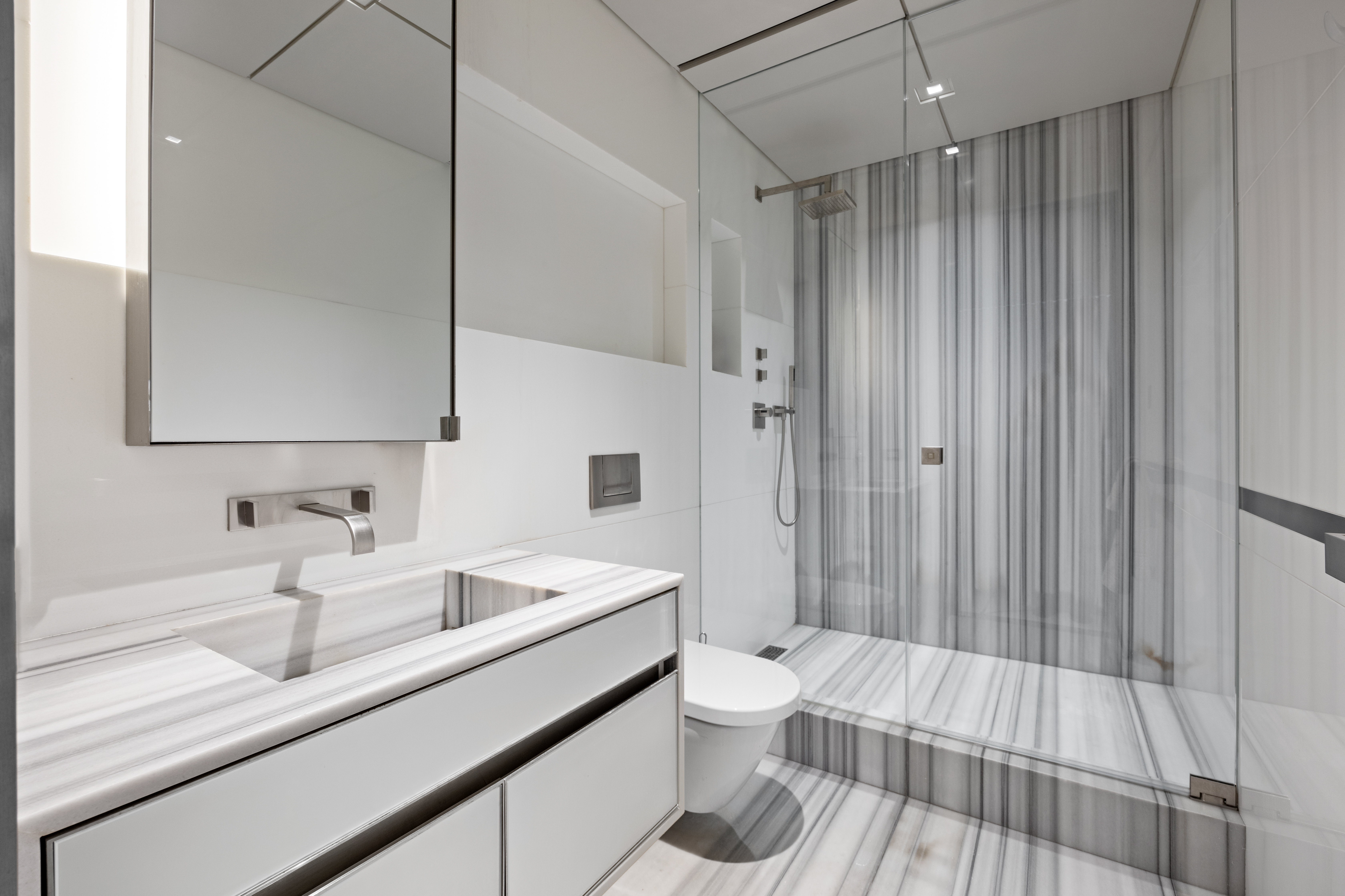 219 East 67th Street, Unit 5 Manhattan, NY 10065 - Photo 13 of 18 a bathroom with a sink a toilet a tub and shower