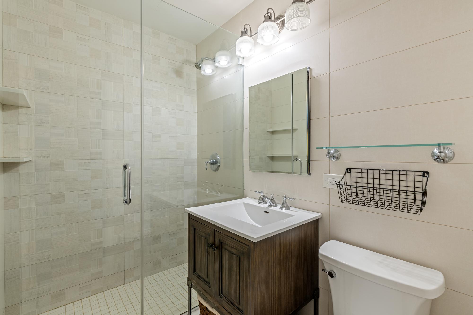 345 East 73rd Street, Unit 11KL Manhattan, NY 10021 - Photo 10 of 12 a bathroom with a sink toilet and shower