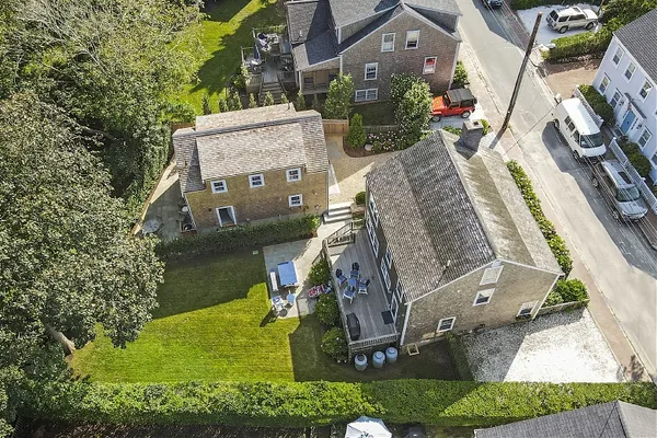 an aerial view of a house with a garden and lake view