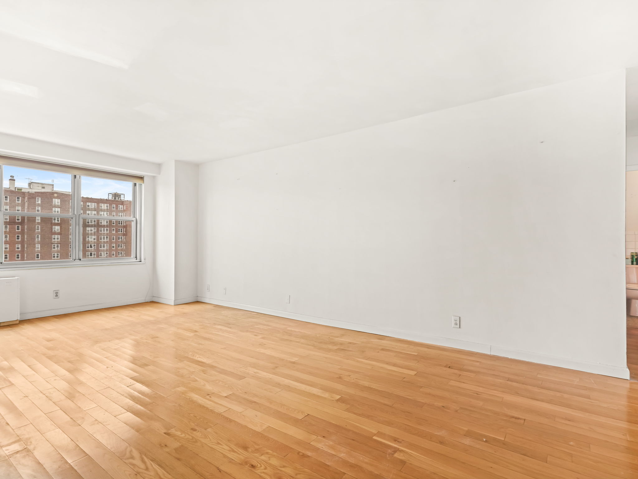 555 Kappock Street, Unit 11J Bronx, NY 10463 - Photo 6 of 24 a view of an empty room with a window