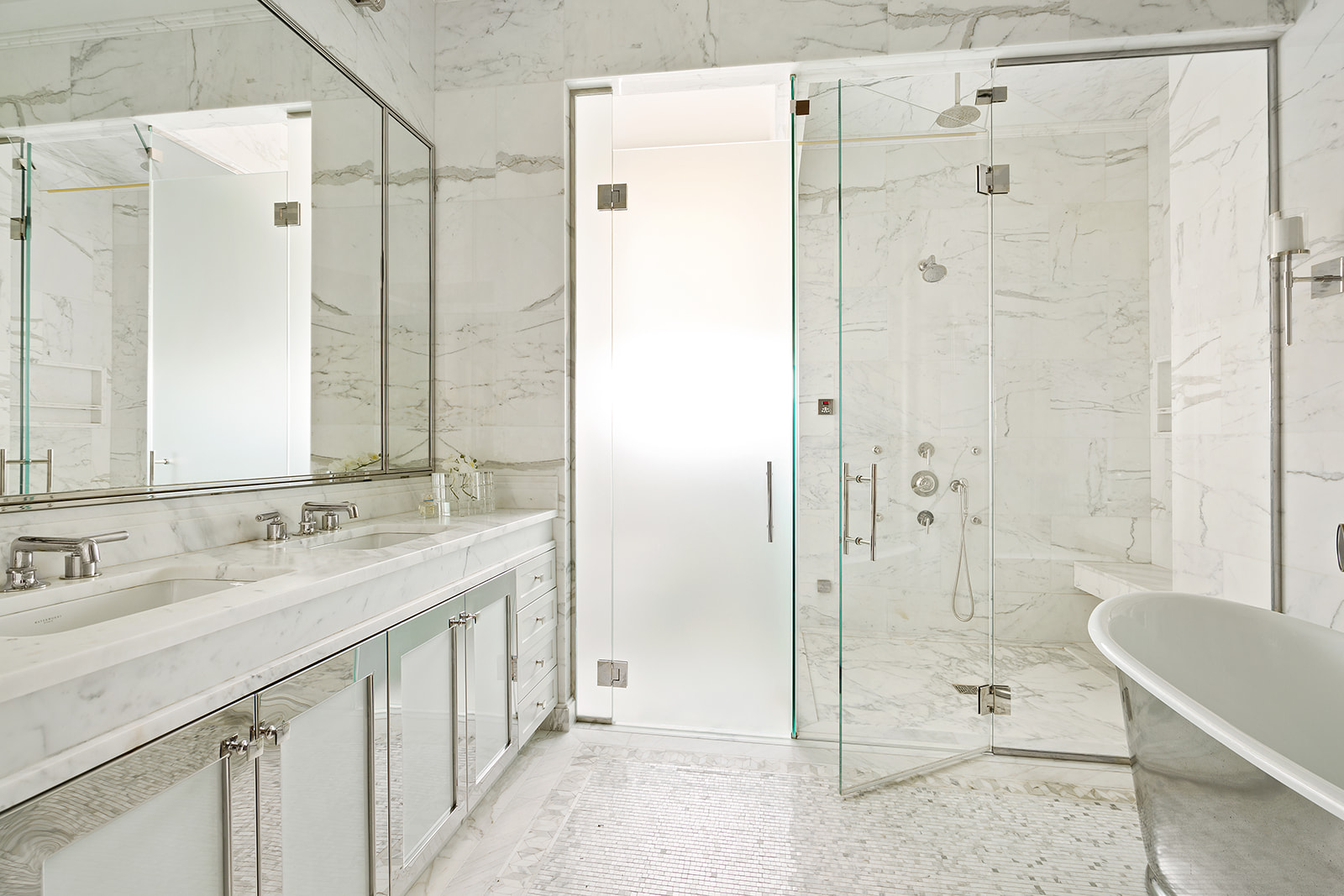 212 West 18th Street, Unit 12E Manhattan, NY 10011 - Photo 5 of 13 a bathroom with a shower sink and mirror