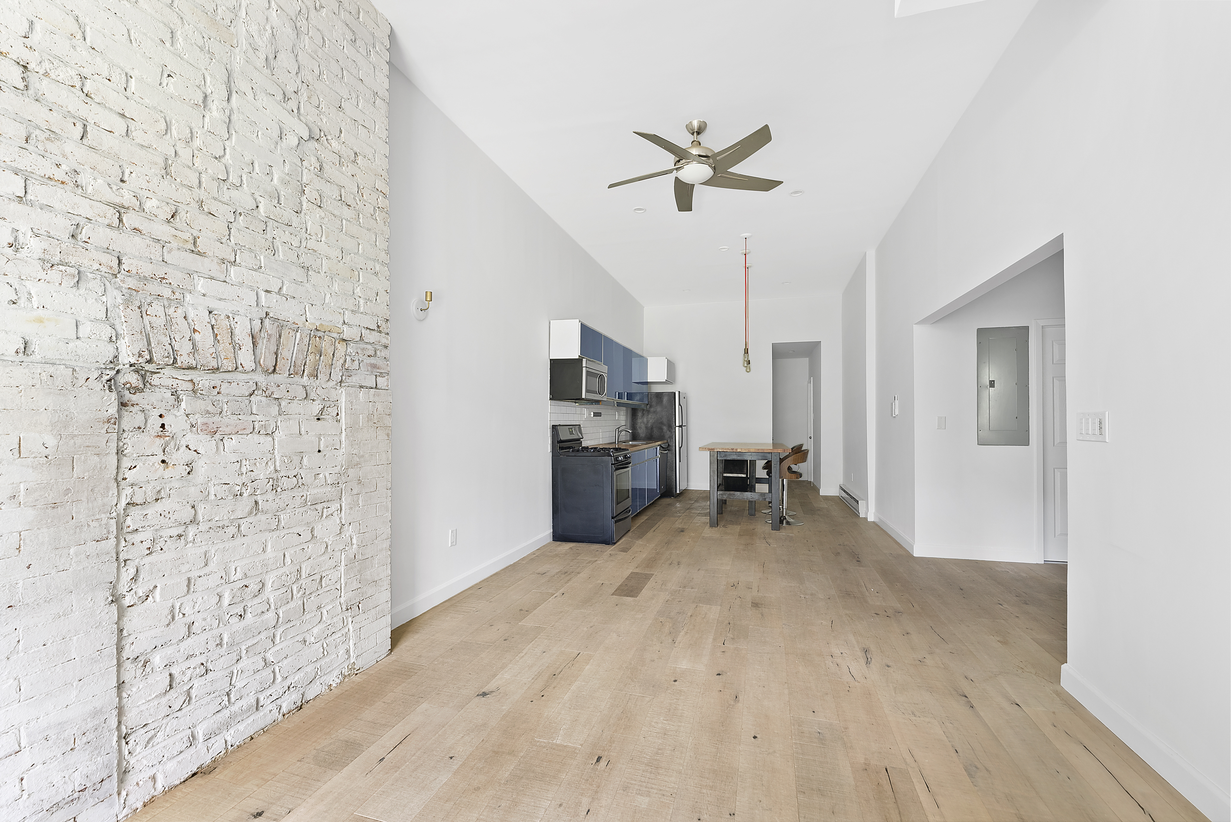 768 Hart Street, Unit 1 Brooklyn, NY 11237 - Photo 3 of 18 a view of empty room with wooden floor and fan