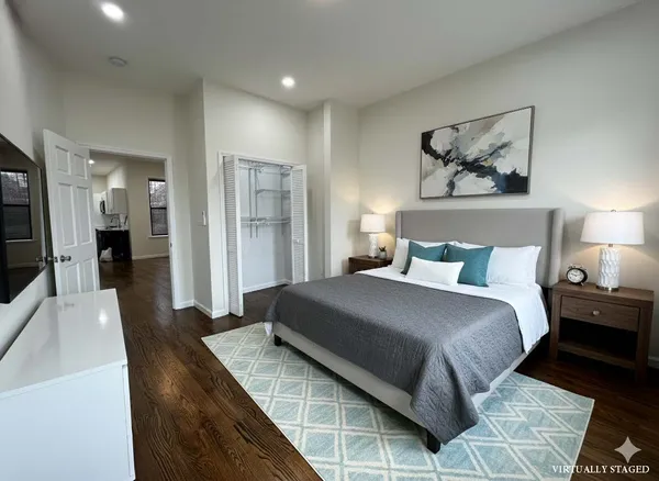 a bedroom with a bed and painting on the wall