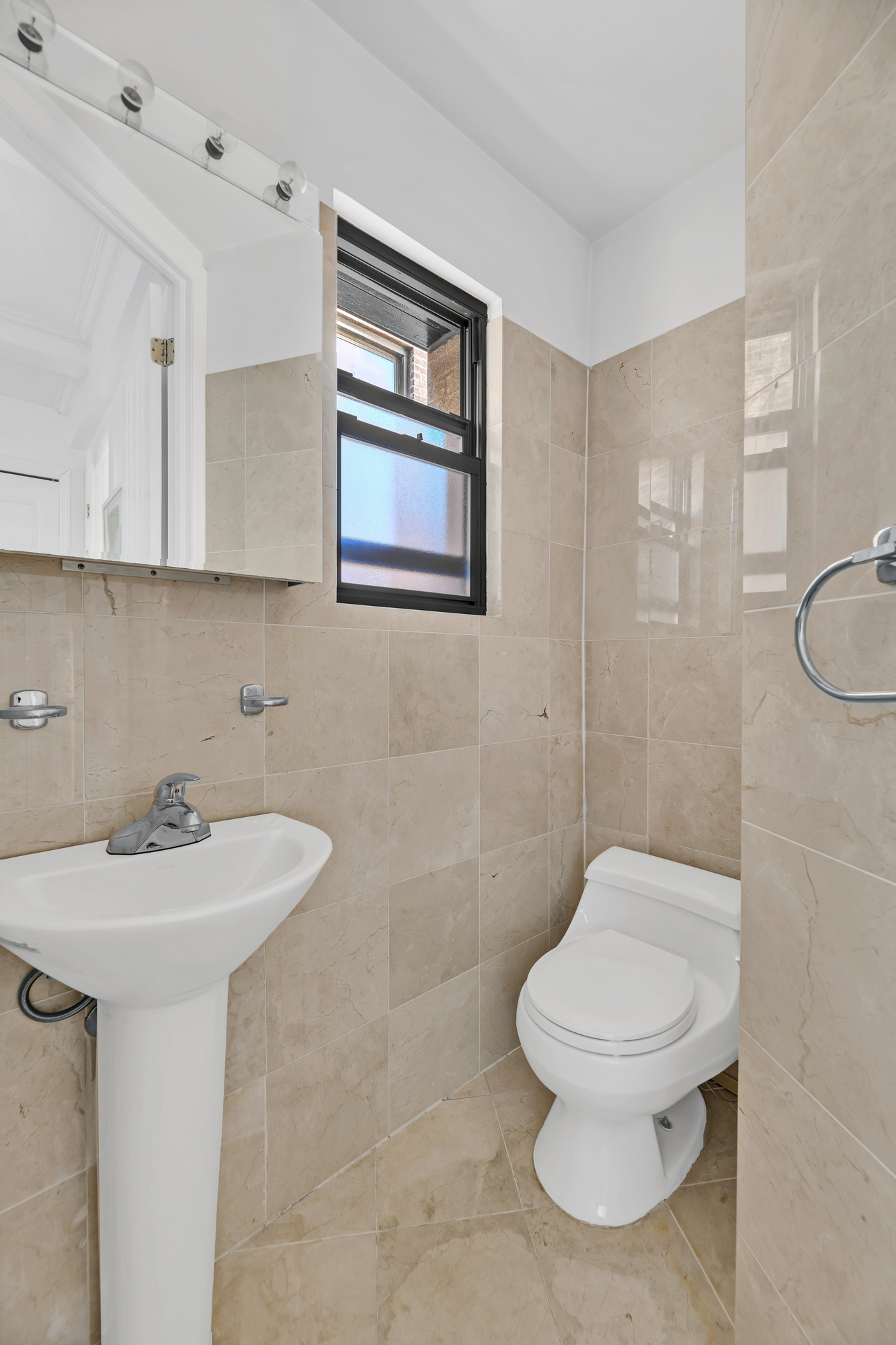 599 West End Avenue, Unit 7BC Manhattan, NY 10024 - Photo 9 of 11 a bathroom with a toilet sink and mirror