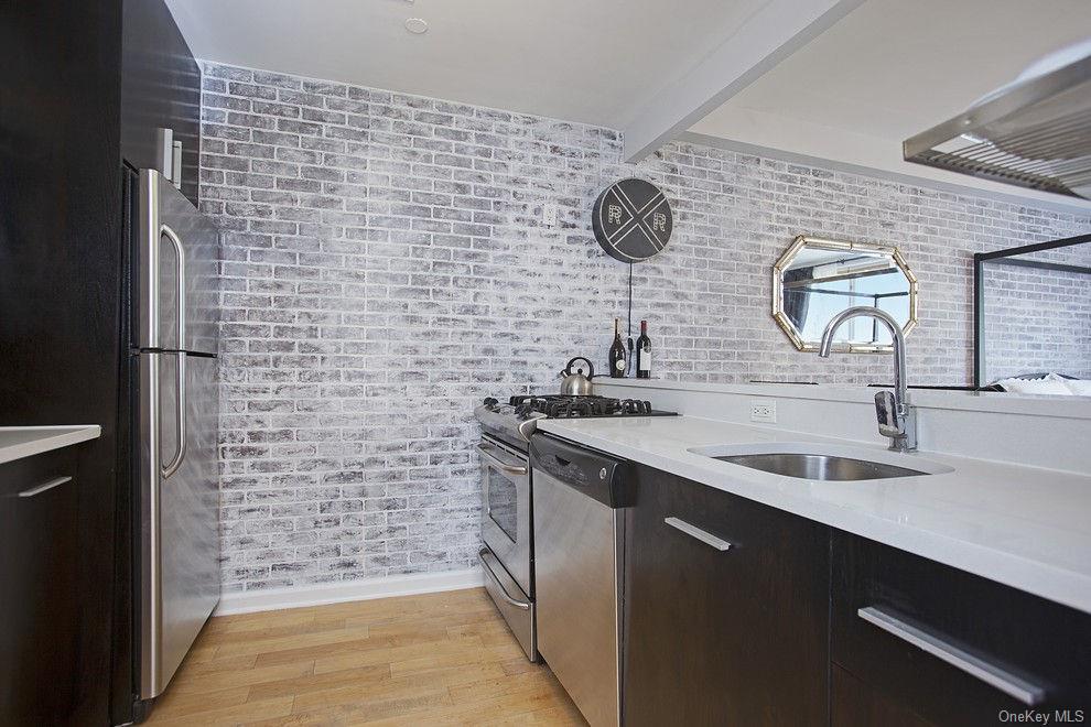 13-11 Jackson Avenue, Unit 4C Queens, NY 11101 - Photo 4 of 7 a bathroom with a sink and a mirror