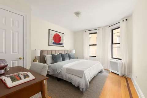 a bedroom with a bed and a painting on the wall