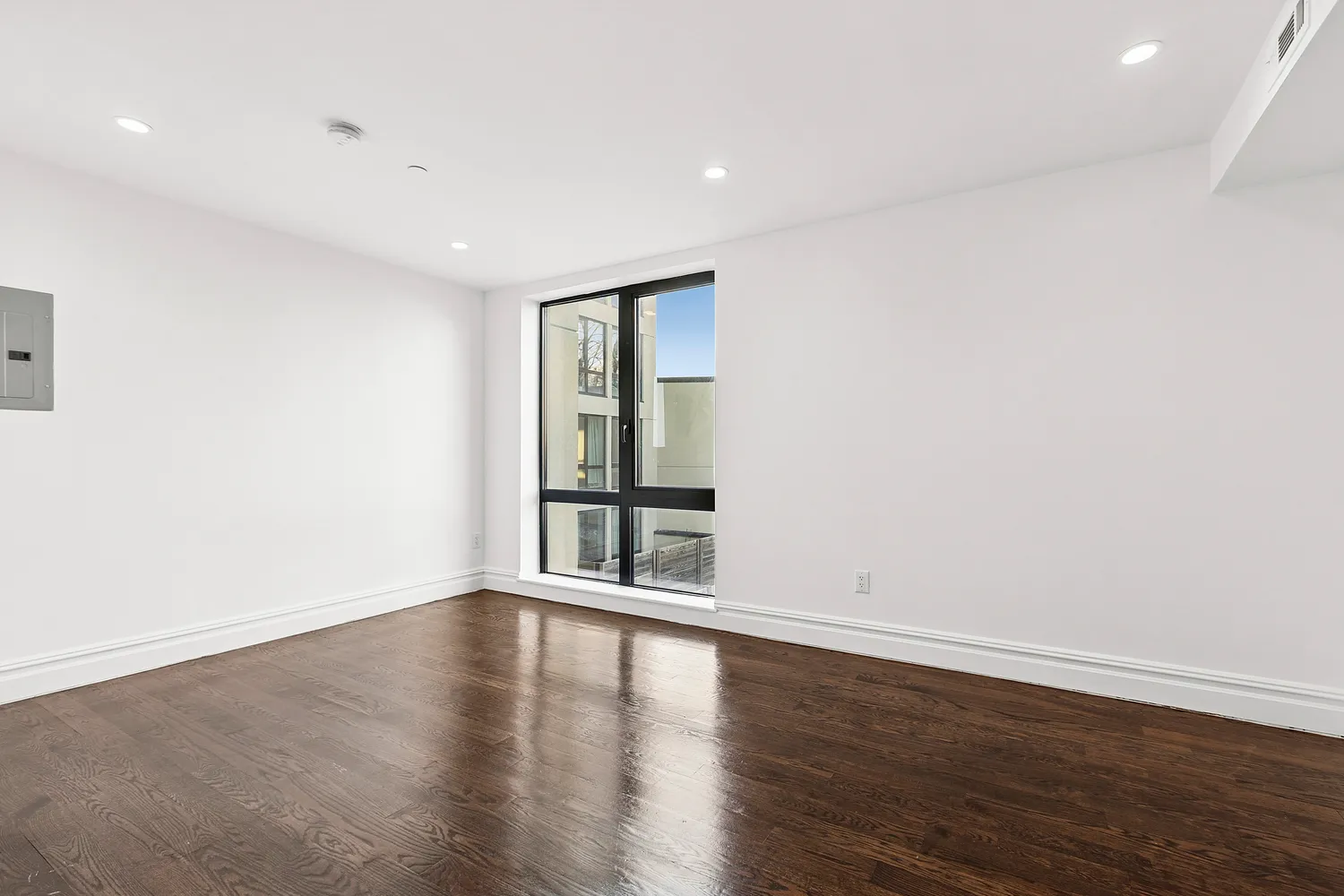 a view of wooden floor and windows in a room