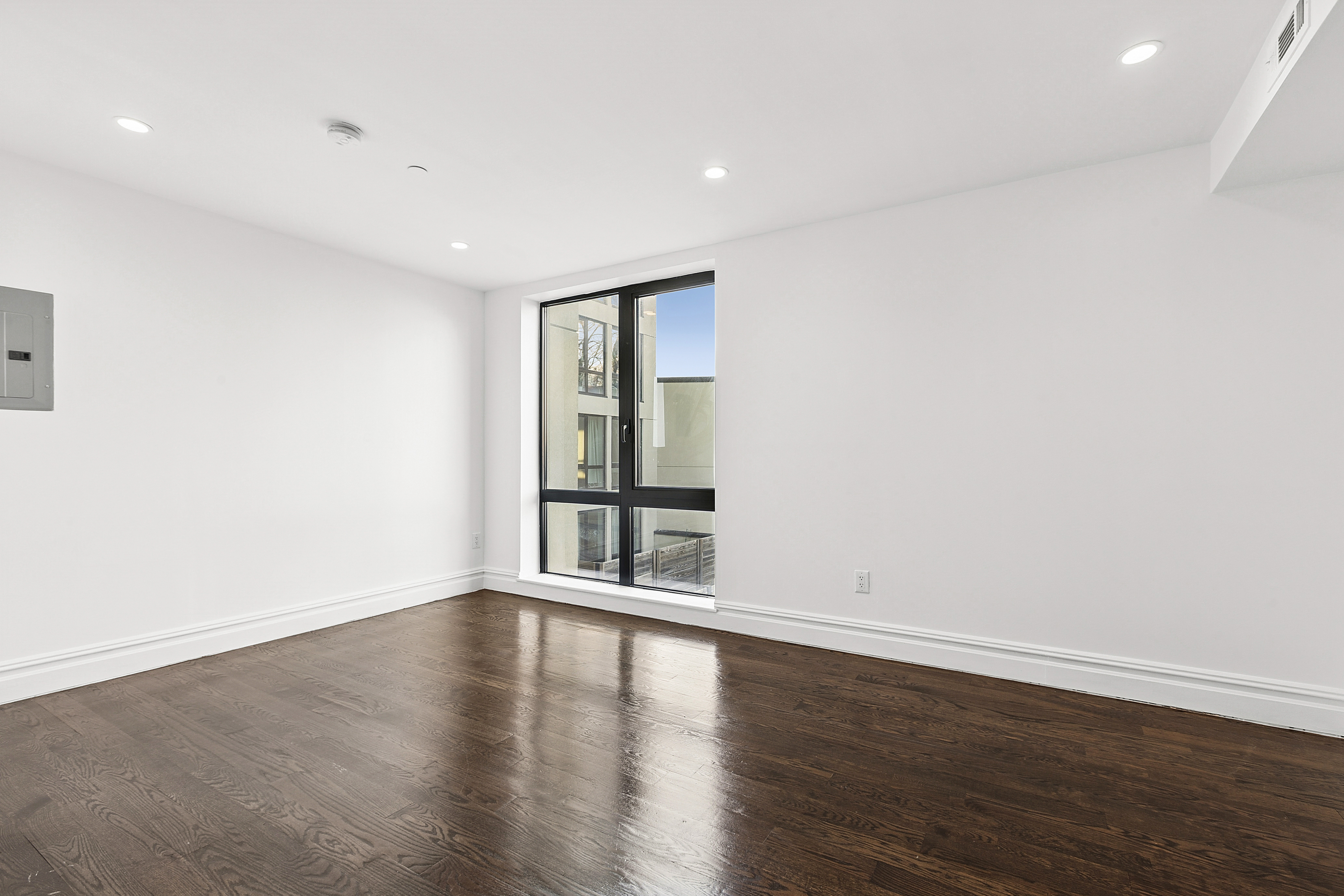 1255 Bushwick Avenue, Unit 3D Brooklyn, NY 11207 - Photo 4 of 6 a view of wooden floor and windows in a room