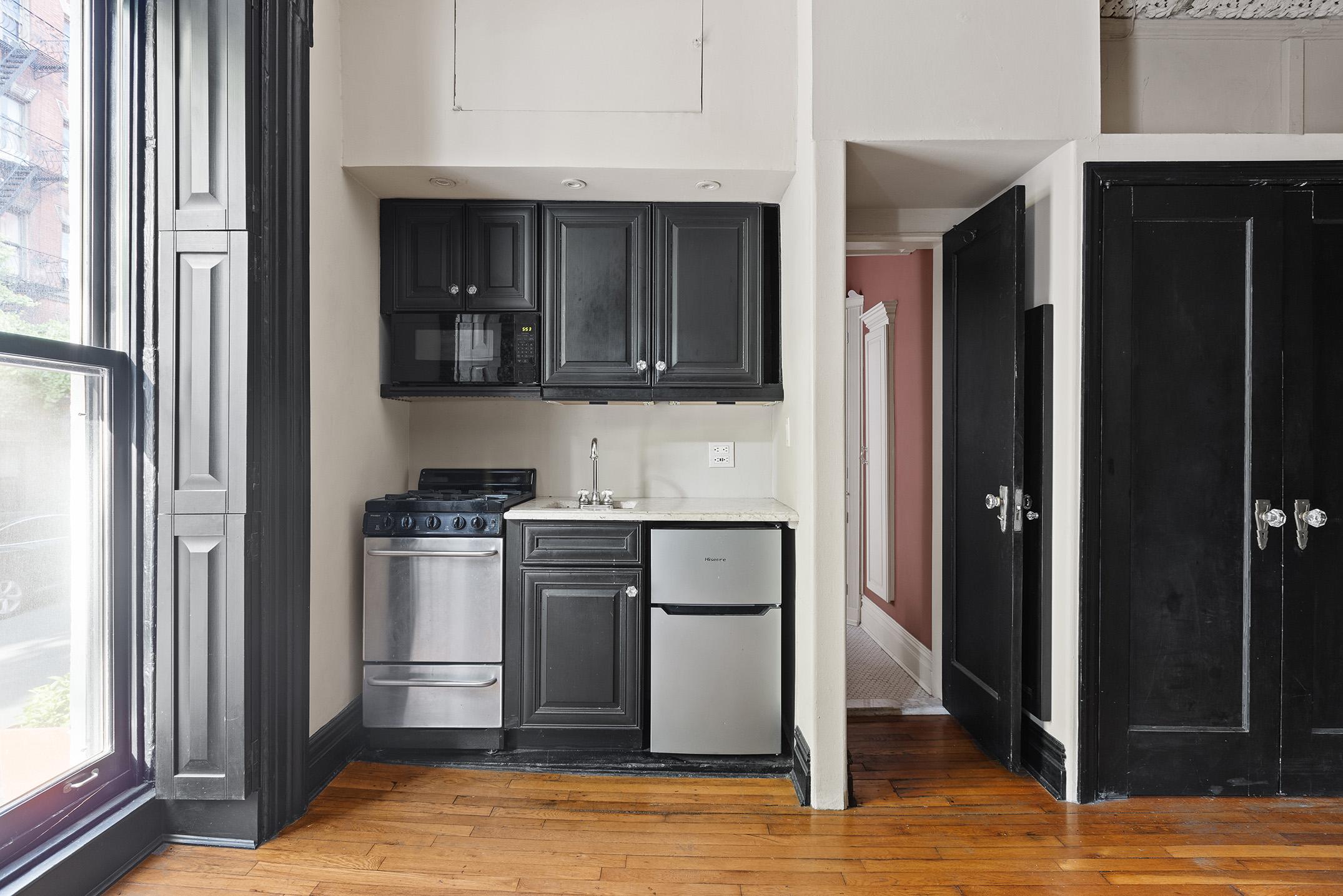 116 Perry Street, Unit J49 Manhattan, NY 10014 - Photo 5 of 6 a kitchen with stainless steel appliances granite countertop a refrigerator and a stove