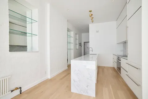 a room with cabinets and a rug