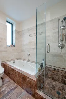 a bathroom with a bathtub and a shower