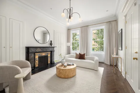 a living room with furniture a window and a fireplace