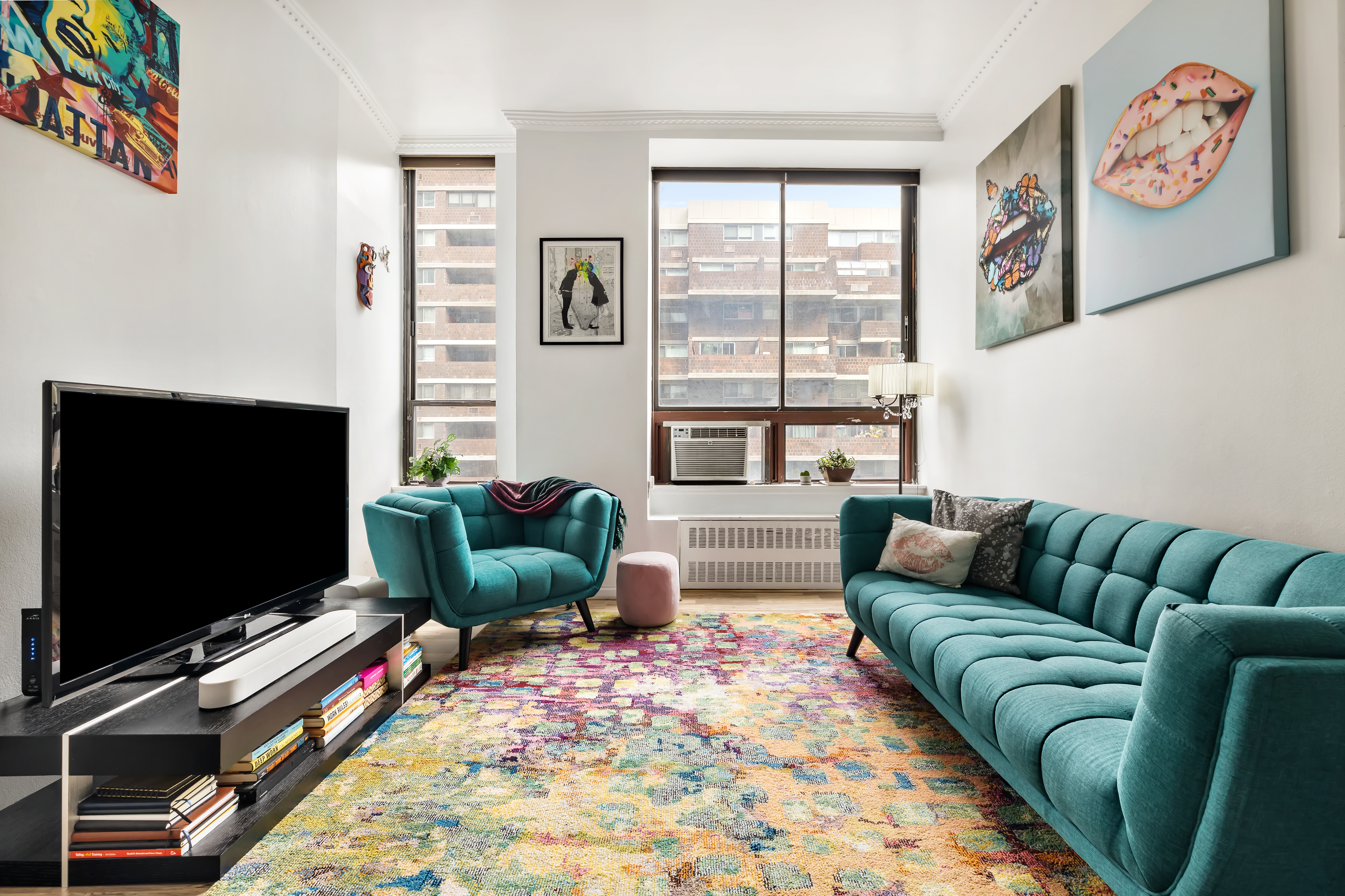 310 East 23rd Street, Unit 5H Manhattan, NY 10010 - Photo 1 of 8 a living room with furniture and a flat screen tv