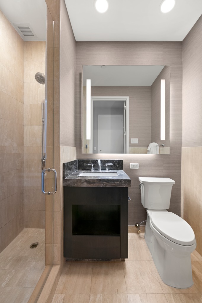 1 Central Park West, Unit 1506 Manhattan, NY 10023 - Photo 8 of 16 a bathroom with a sink toilet and shower