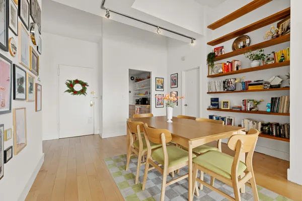 a dining room with furniture and a book shelf