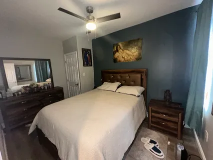 a bedroom with a bed and window