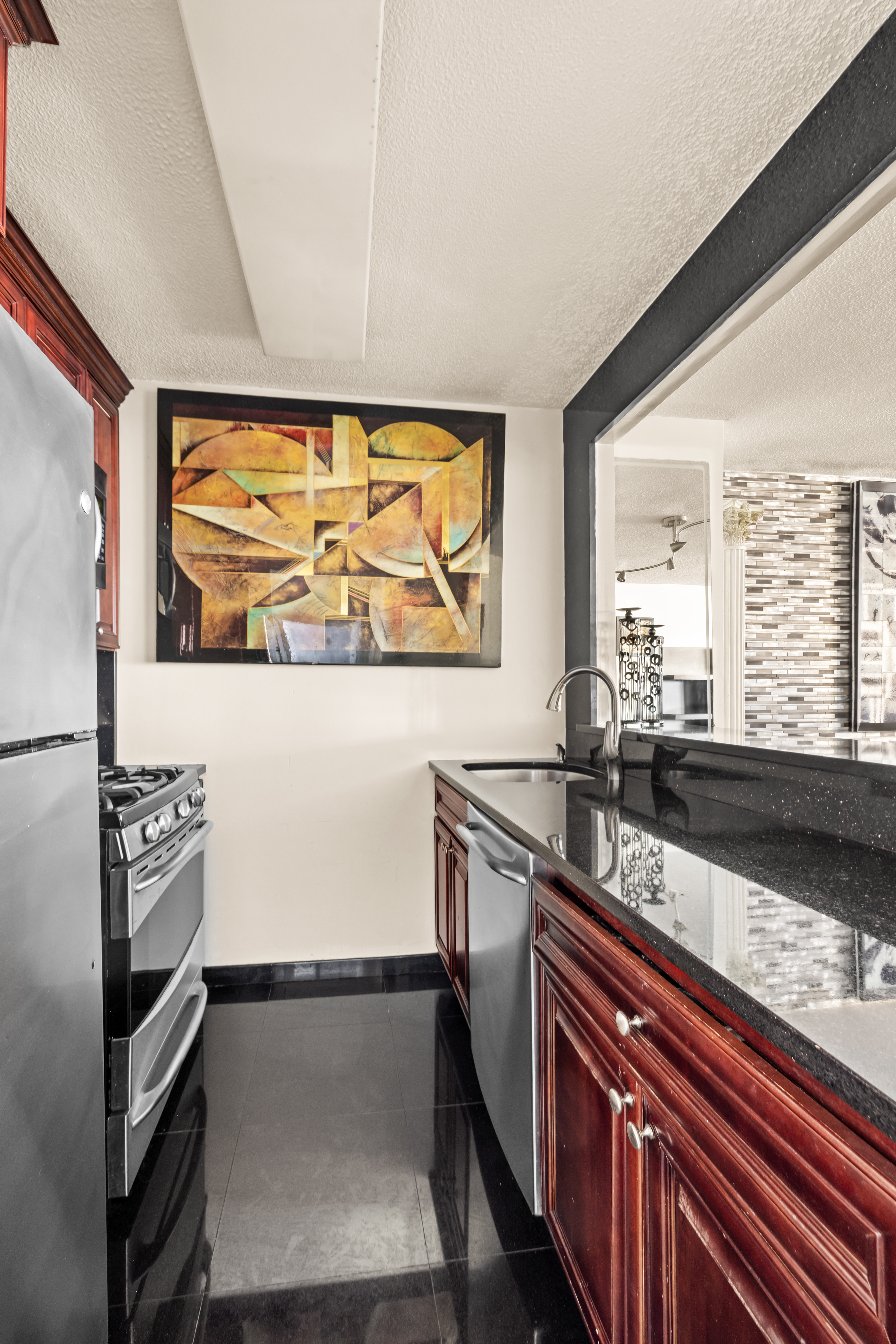 330 East 38th Street, Unit 26F Manhattan, NY 10016 - Photo 3 of 11 a view of a large kitchen with a sink and wooden floor
