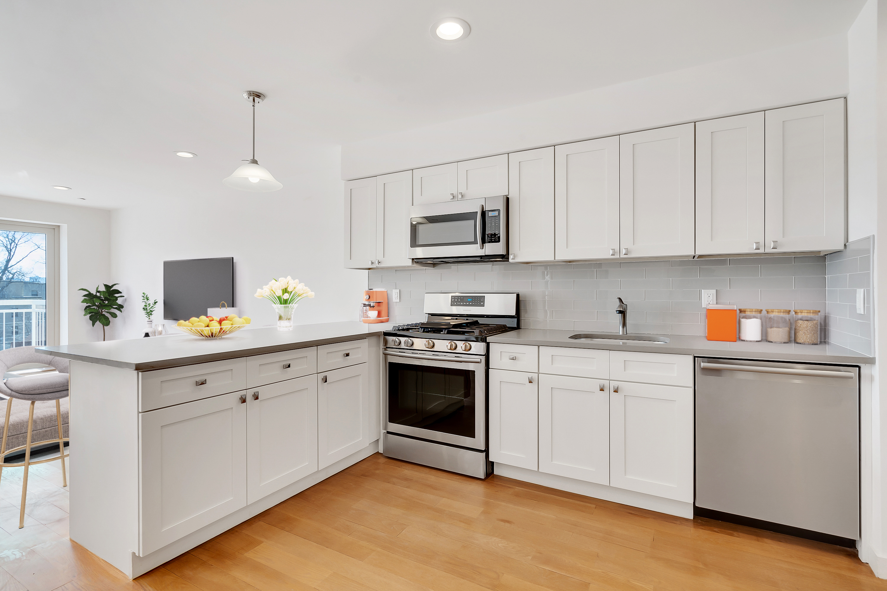 26-20 14th Place, Unit 3D Queens, NY 11102 - Photo 3 of 12 a kitchen with cabinets stainless steel appliances and a sink