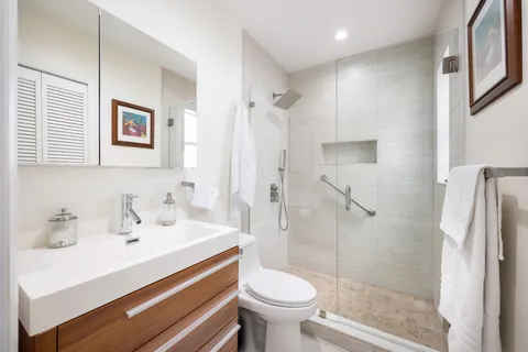 a bathroom with a sink toilet and shower