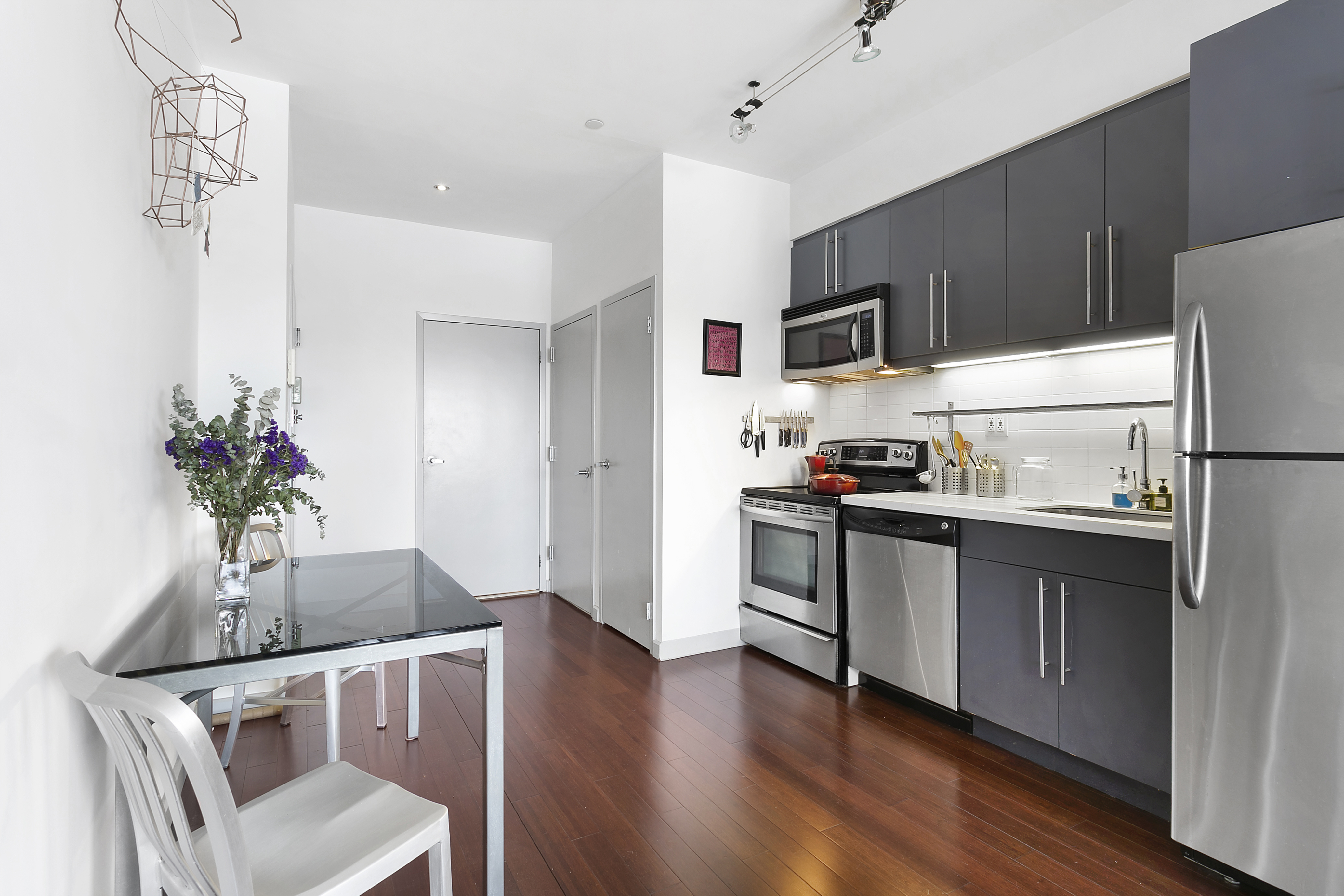 38 Wilson Avenue, Unit 4D Brooklyn, NY 11237 - Photo 3 of 10 a kitchen with granite countertop stainless steel appliances a sink and a refrigerator