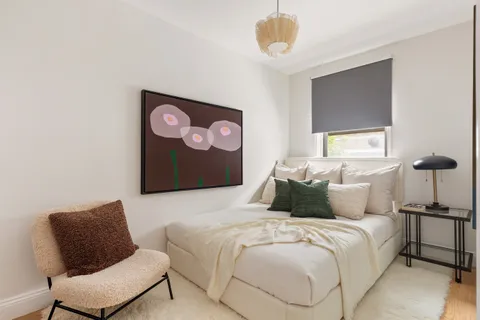 a bedroom with a bed and a chair