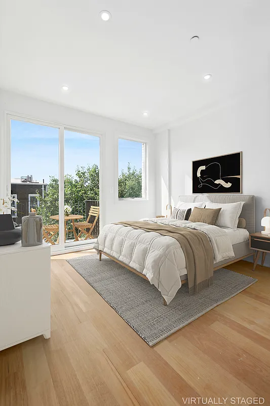 483 Hart Street, Unit PH Brooklyn, NY 11221 - Photo 6 of 17 a bedroom with a large bed and a large window