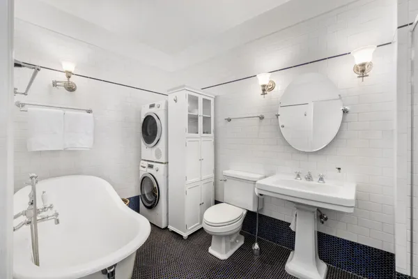 a bathroom with a toilet a sink and mirror