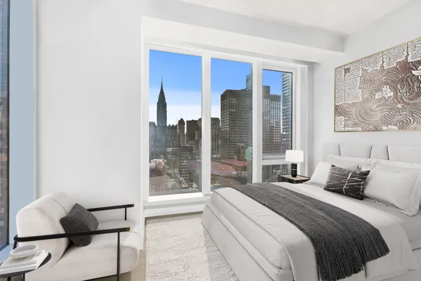 a bedroom with a large bed and a large window