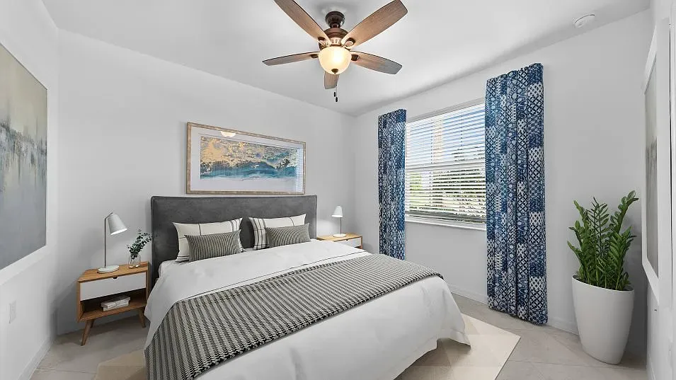 a bedroom with a balcony a bed and a potted plant