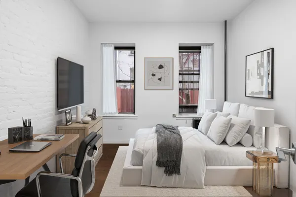 a bedroom with a bed and a flat screen tv