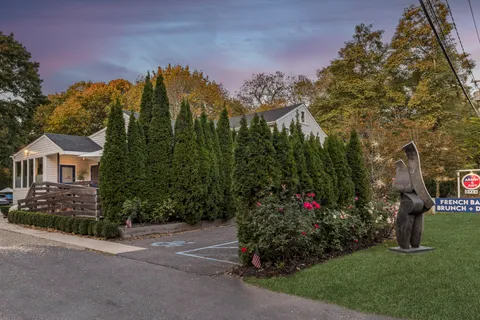 a view of a house with a yard and garden