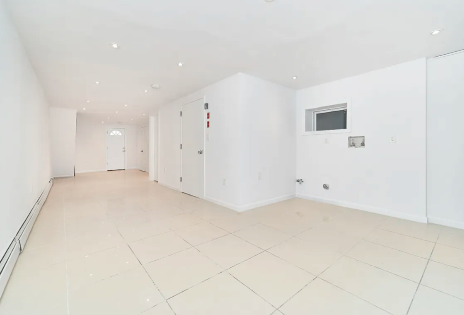 705 Schenck Avenue Brooklyn, NY 11207 - Photo 6 of 8 an empty room with white walls