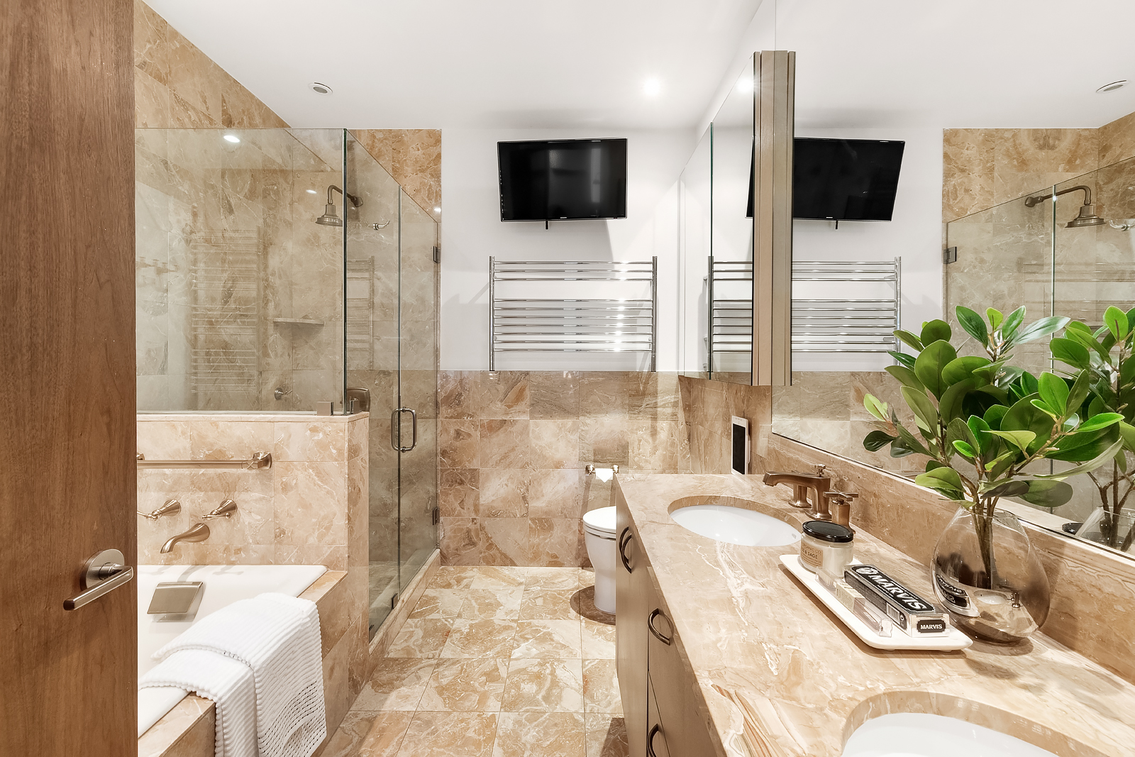 1 Central Park West, Unit 30E Manhattan, NY 10023 - Photo 10 of 12 a bathroom with a granite countertop sink a mirror a bathtub and shower