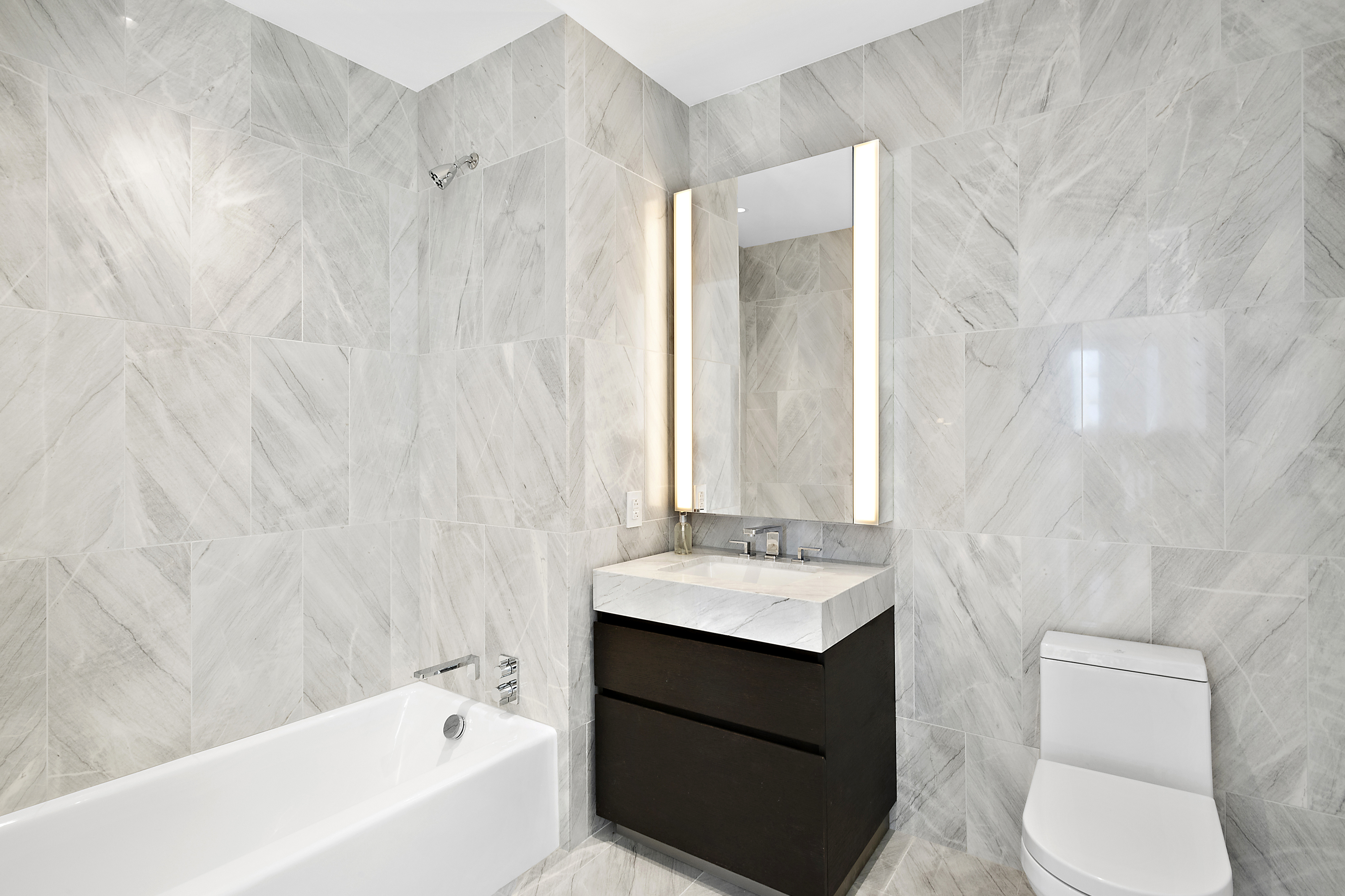 15 Hudson Yards, Unit 26C Manhattan, NY 10001 - Photo 7 of 8 a bathroom with a sink and a mirror