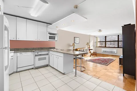 a kitchen with granite countertop cabinets a sink and a stove